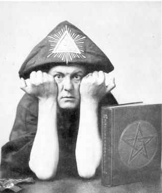 Aleister Crowley in A.'.A.'. regalia making the sign "Vir."